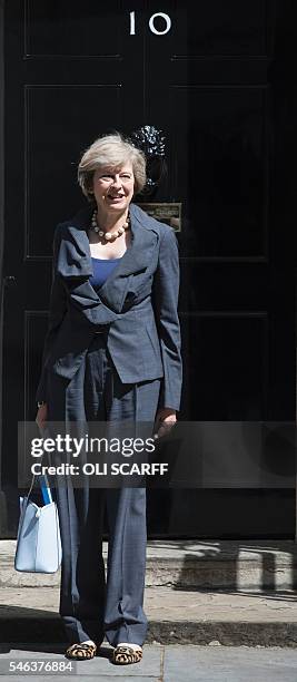 New Conservative Party leader Theresa May poses for a photograph as she leaves 10 Downing Street in London on July 12 atfer attending Prime Minister...