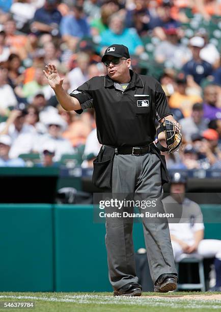 Home plate umpire Andy Fletcher gestures to the Seattle Mariners dugout after a strike was called on a teammate during a game against the Detroit...