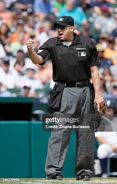 Home plate umpire Andy Fletcher gestures to the Seattle Mariners dugout after a strike was called on a teammate during a game against the Detroit...