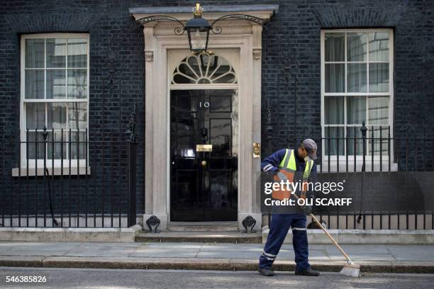 Workman cleans the street outside 10 Downing Street in London on July 12 as Prime Minister David Cameron chairs his last Cabinet meeting. David...