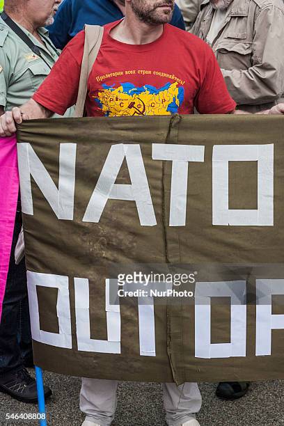 Protester with a banner against NATO in a demonstration during the NATO Warsaw Summit in Poland on 9 July 2016.