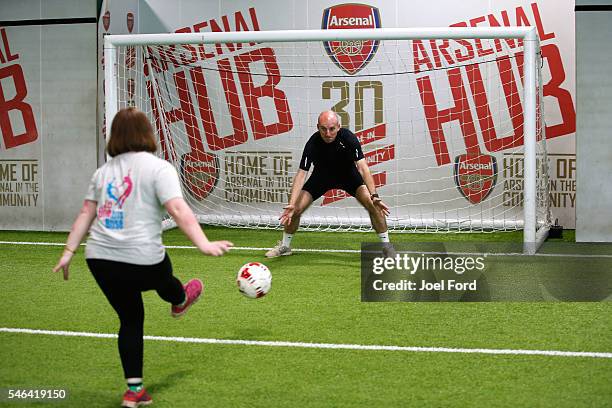 Referee Mike Riley plays football with children at the Arsenal Community Hub at Emirates Stadium during the Premier League Referees Charity Bike Ride...