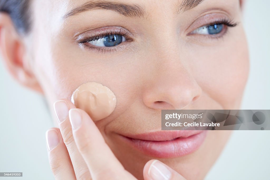 Woman applying foundation