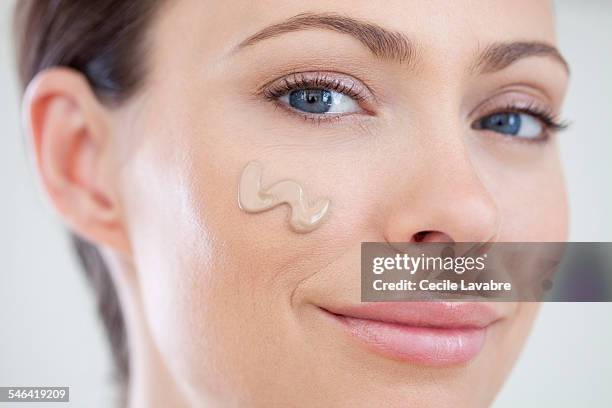 woman with foundation on cheek - make up foundation stock pictures, royalty-free photos & images