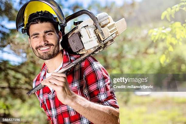 handsome lumberjack with chainsaw - man with chainsaw stock pictures, royalty-free photos & images