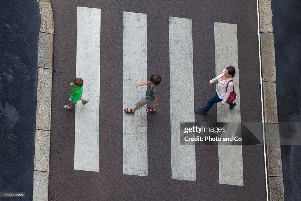 Family crossing a pedestrian crossing