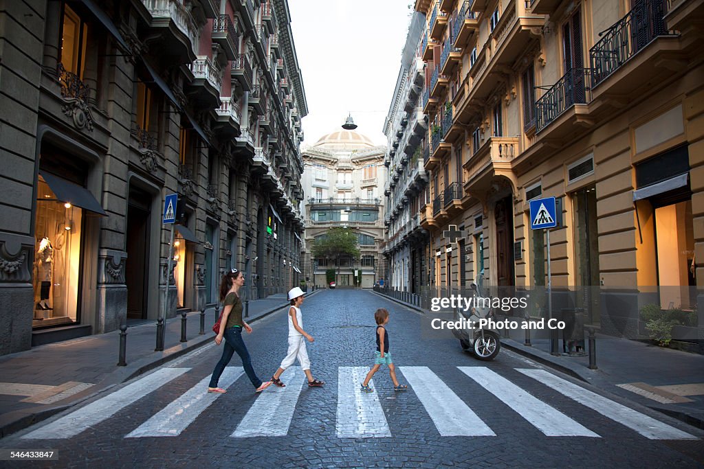 Family crossing a pedestrian crossing