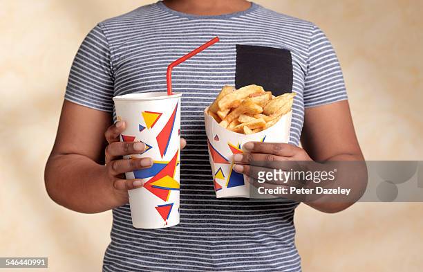 obese boy with snack - ready meal photos et images de collection