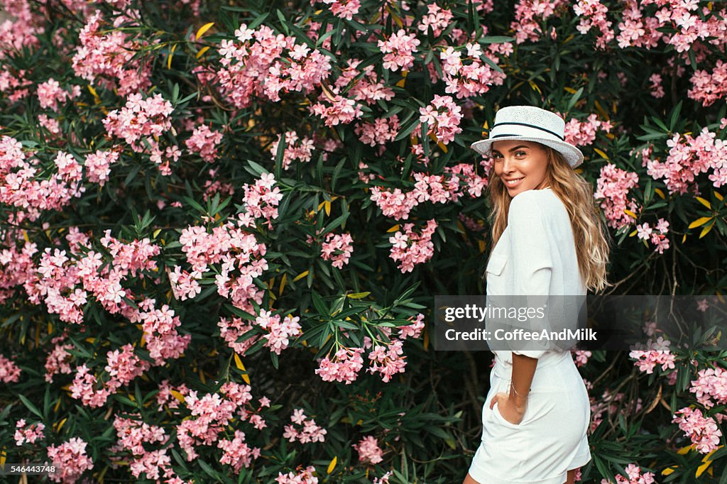 Beautiful girl on the background of spring bush