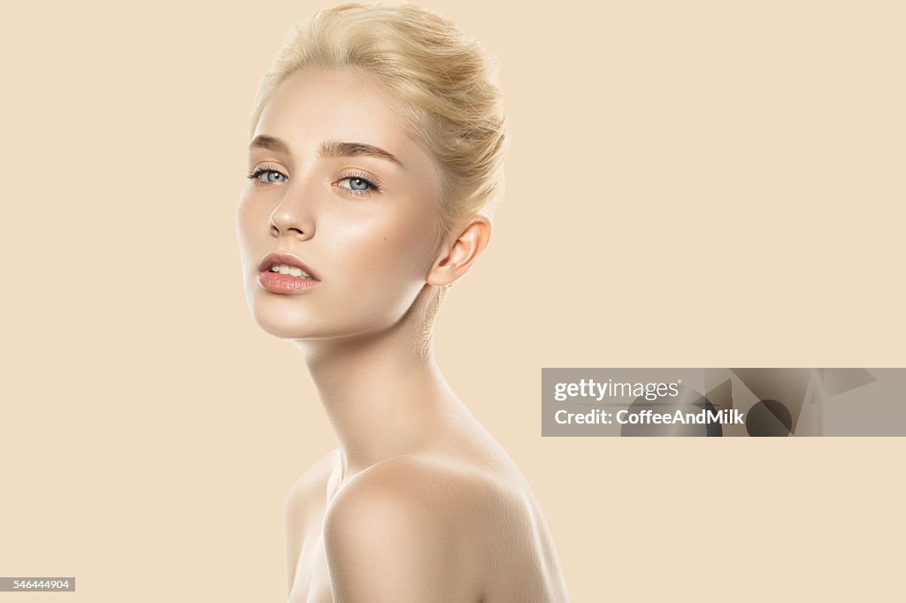 Studio shot of young beautiful woman. Professional make-up.