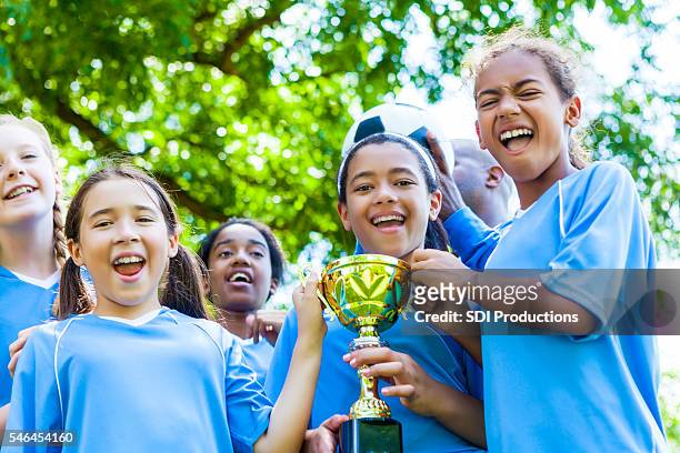 girls soccer team celebrates victory - sports trophy stock pictures, royalty-free photos & images