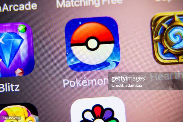 pokemon go app icon on iphone - pokemon go stock pictures, royalty-free photos & images
