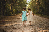 Two little girls on a forest road
