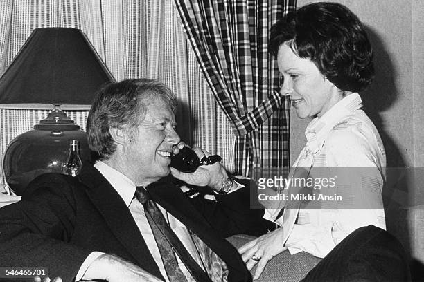 American politician and US Presidential candidate Jimmy Carter and his wife, Rosalynn Carter, talk on the telephone after his victory in the...