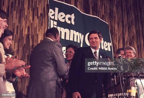 Future US First Lady Rosalynn Carter shakes hands with American politician Samuel L Evans as Senator Birch Bayh and her husband, American politician...