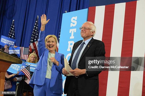 Presumptive Democratic presidential nominee Hillary Clinton and Bernie Sanders take the stage at Portsmouth High School July 12, 2016 in Portsmouth,...