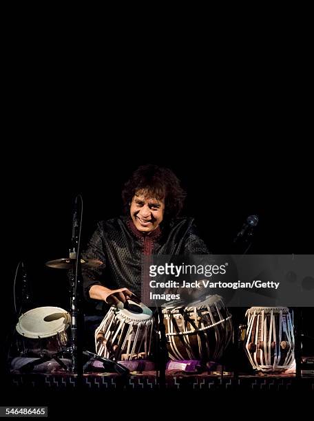 Indian musician Zakir Hussain plays tabla as he leads his Pulse of the World Ensemble during a performance at Carnegie Hall, New York, New York,...
