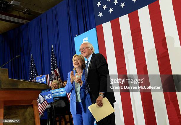 Presumptive Democratic presidential nominee Hillary Clinton and Bernie Sanders take the stage at Portsmouth High School July 12, 2016 in Portsmouth,...