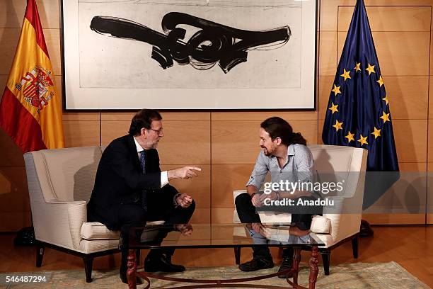 Spanish Prime Minister Mariano Rajoy and Leader of left wing party Unidos Podemos Pablo Iglesias talk each other during their meeting at Spanish...