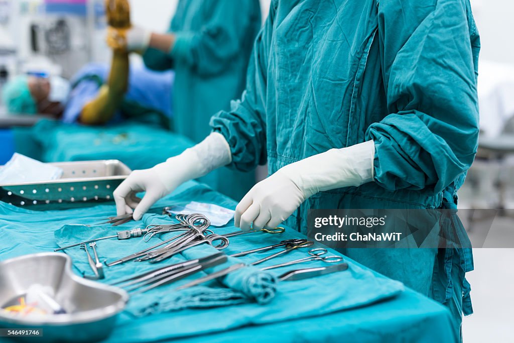 Scrub nurse preparing surgical instruments for surgery