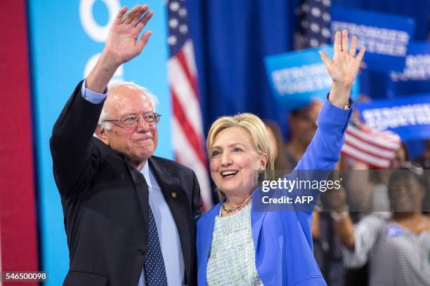 Presumptive Democratic presidential candidate Hillary Clinton and Bernie Sanders waves after speaking at a rally in Portsmouth, New Hampshire where...