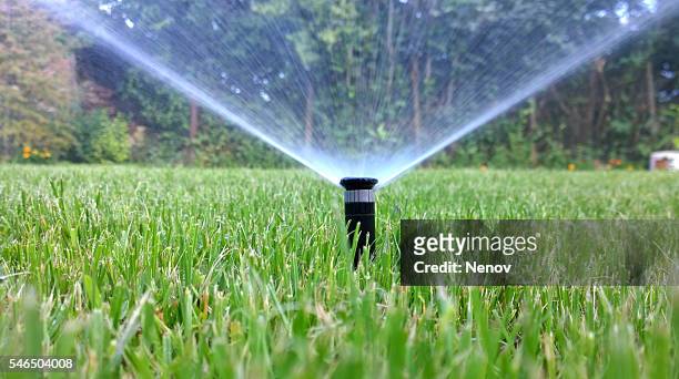 sprinkler of automatic watering - water supply stock-fotos und bilder