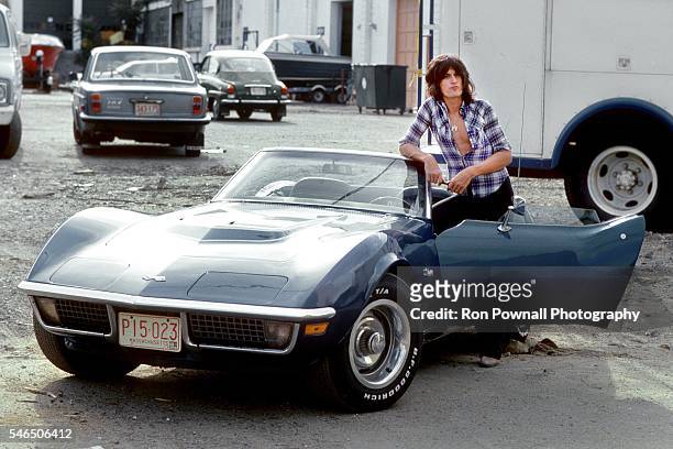 Aerosmith guitarist Joe Perry poses for a portrait with his 1975 Corvette Stingray on August 10, 1975 in Waltham, Massachusetts.