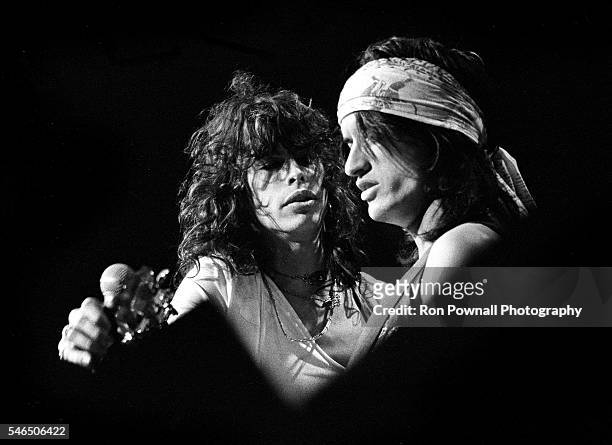 Aerosmith singer Steven Tyler with guitarist Joe Perry perform onstage at the Boston Garden on December 17, 1974 in Boston, Massachusetts.