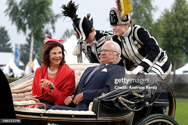 Queen Silvia of Sweden and King Carl XVI Gustaf of Sweden ride a horse carriage during the opening ceremony of the CHIO 2016 on July 12, 2016 in...