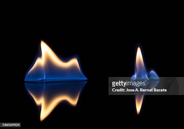 flames of orange and blue with reflections on a black background color - cyclone warning stock pictures, royalty-free photos & images