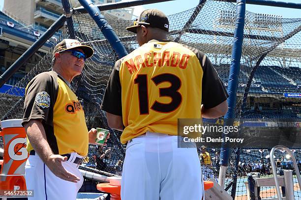 Manager Ned Yost of the Kansas City Royals talks to Manny Machado of the Baltimore Orioles prior to the 87th Annual MLB All-Star Game at PETCO Park...