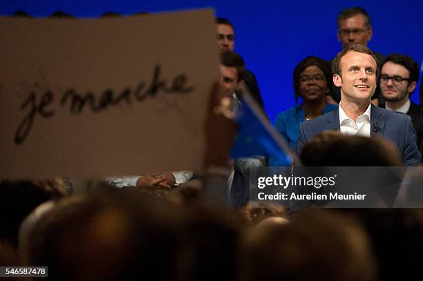 French Minister of Economic, Emmanuel Macron waves at the crowd as he arrives for the 'En Marche' political party meeting at Theatre de la Mutualite...