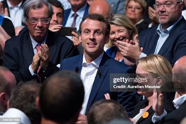 French Minister of Economic, Emmanuel Macron waves at the crowd as he arrives for the 'En Marche' political party meeting at Theatre de la Mutualite...