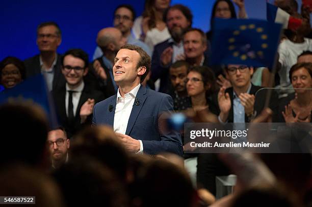 French Minister of Economic, Emmanuel Macron waves at the crowd as he arrives for the 'En Marche' political party meeting at Theatre de la Mutualite...