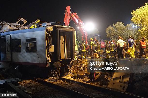 Rescuers work after a head-on collision between two trains, near Corato, in the southern Italian region of Puglia on July 12, 2016. At least 20...