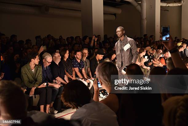 Model walks the runway of the Robert Geller show during New York Fashion Week: Men's S/S 2017 at Skylight Clarkson Square on July 12, 2016 in New...