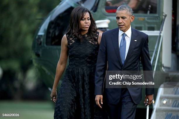 President Barack Obama and first lady Michelle Obama walk across the South Lawn after returning to the White House on Marine One July 12, 2016 in...