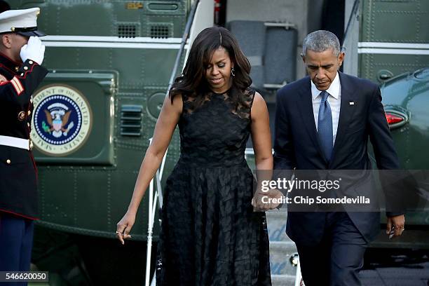 President Barack Obama and first lady Michelle Obama walk across the South Lawn after returning to the White House on Marine One July 12, 2016 in...