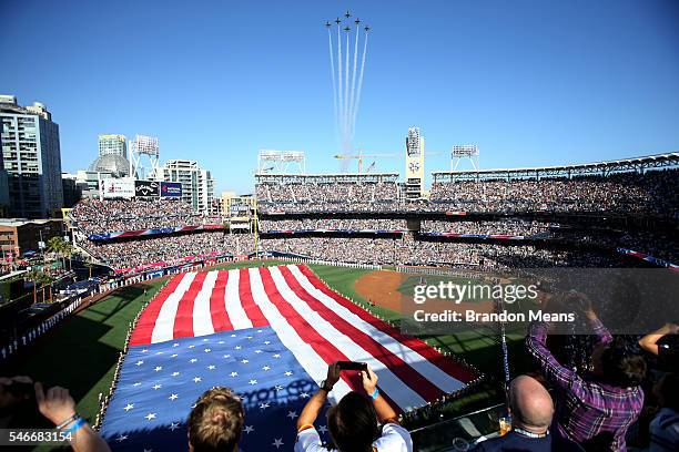 Players stand on the field during the National Anthem as a military flyover takes place prior to the 2016 MLB All-Star Game at Petco Park on Tuesday,...