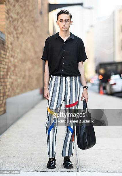 Eric Jess is seen outside the Robert Geller show wearing a Revolve shirt, Sold Out pants, Marc Jacobs shoes, Marc Jacobs bag and a Movado watch...