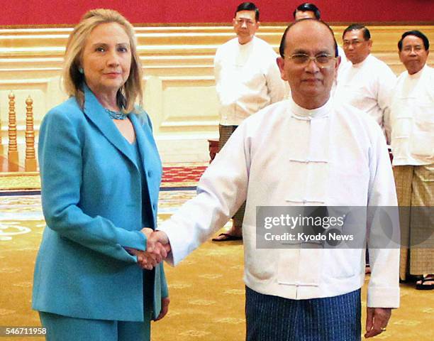 Myanmar - U.S. Secretary of State Hillary Clinton shakes hands with Myanmar President Thein Sein at the presidential office in Myanmar's...