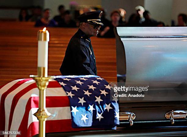 Dallas police Chief David Brown places his hand on a casket for slain Dallas police Sgt. Michael Smith during a visitation for his body at Mary...