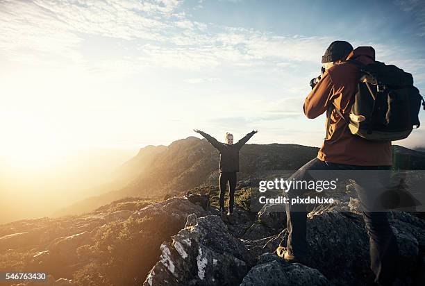 capturing memories on the mountain - photographer stock pictures, royalty-free photos & images