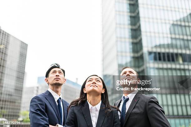 business japanese team standing togetherness - 3 men looking up stock pictures, royalty-free photos & images