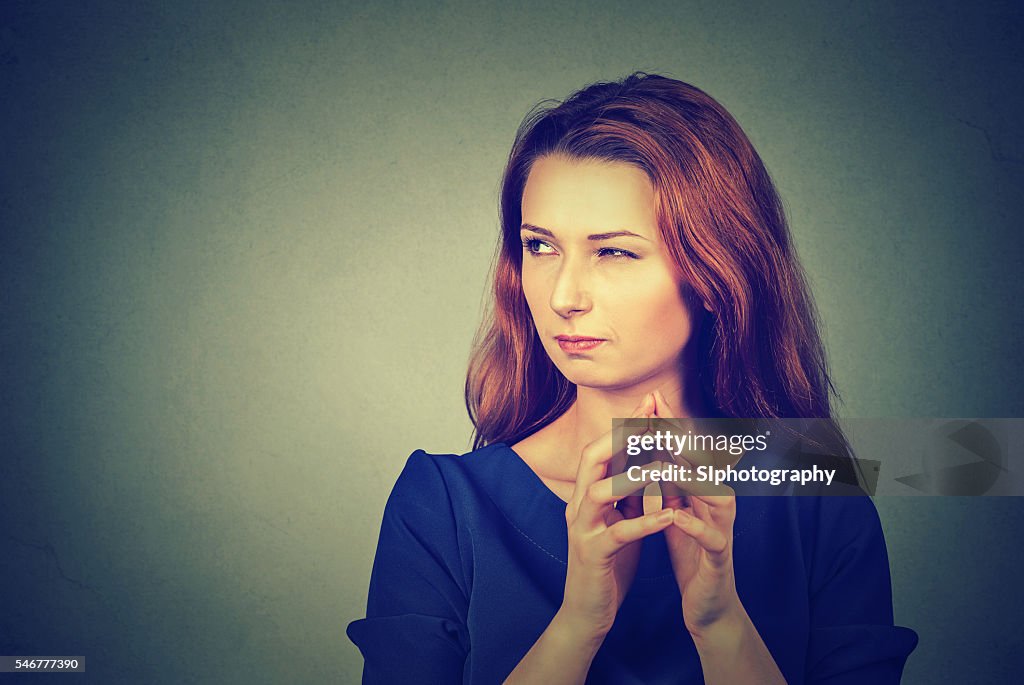 Sneaky, sly, scheming young woman plotting something