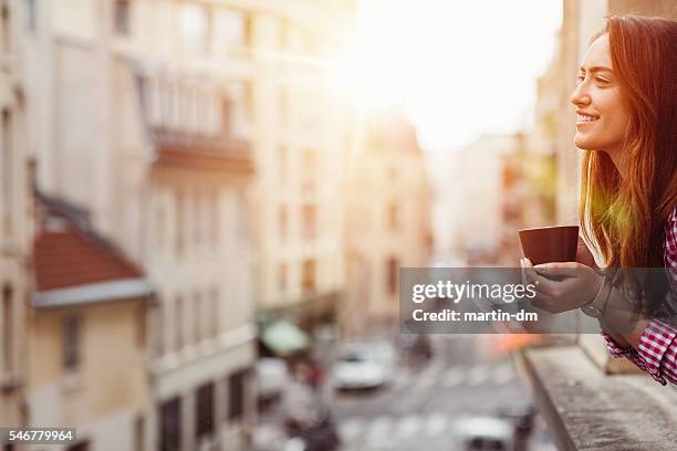 happy woman drinking coffee at the window - saturday stock pictures, royalty-free photos & images