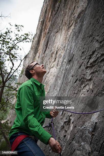 climber belays friend on ascent - wonderlust2015 stock pictures, royalty-free photos & images