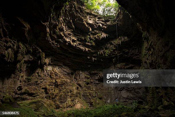 man alone descends ancient cave - san luis potosi ストックフォトと画像