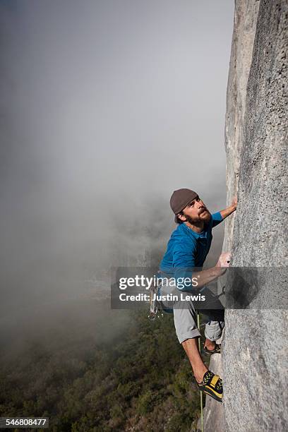 solo climber ascends rock wall - wonderlust2015 stock pictures, royalty-free photos & images