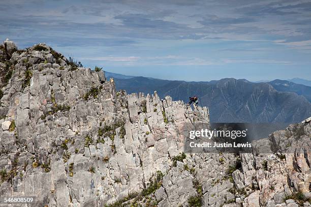 man alone climbs on brittle ridgetop - wonderlust2015 stock pictures, royalty-free photos & images